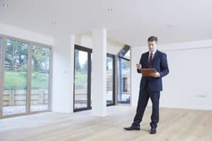 Property Valuation Man With Notebook and Pen in House | Taxwise Australia | 08 6216 4309