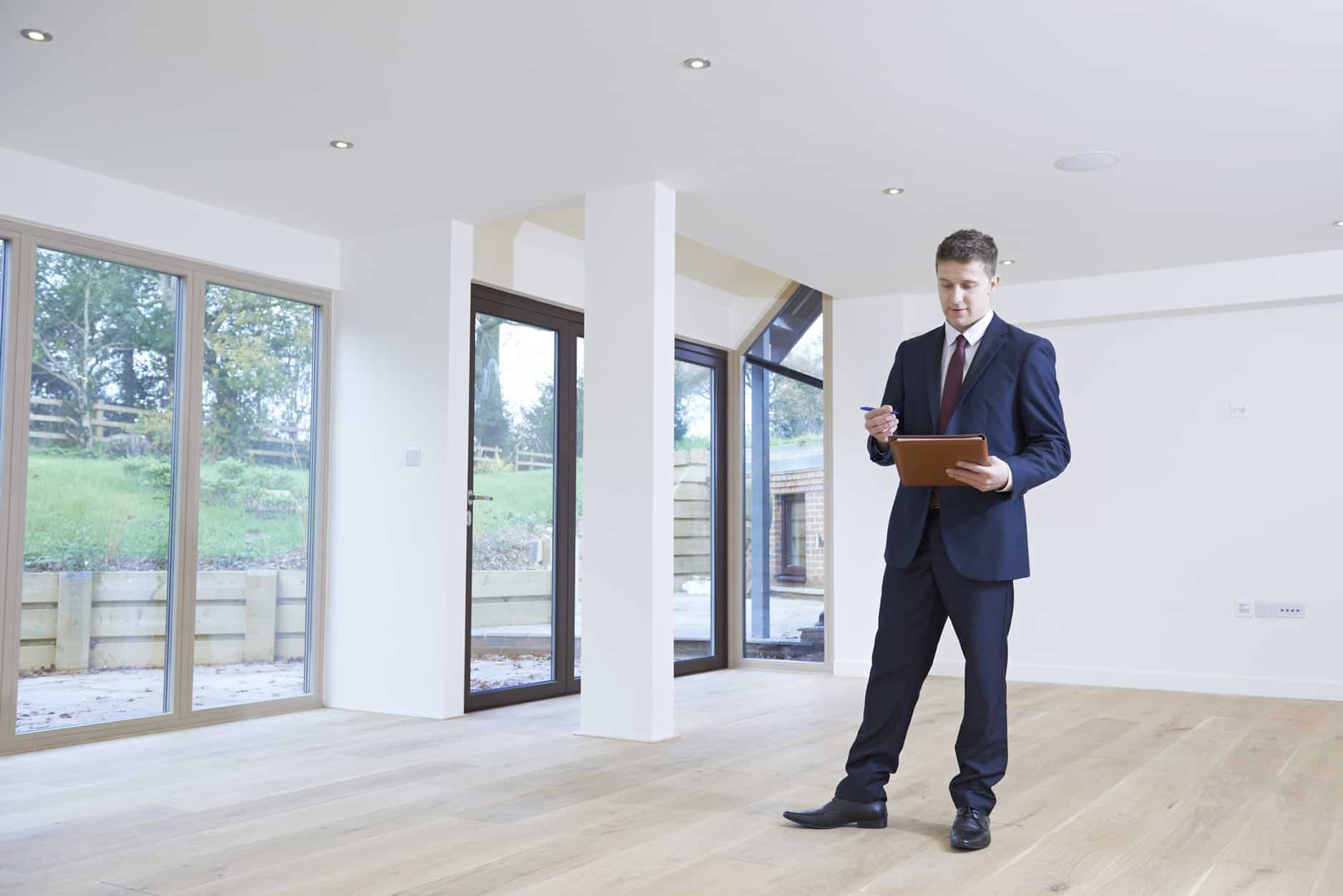Property Valuation Man With Notebook and Pen in House | Taxwise Australia | 08 6216 4309